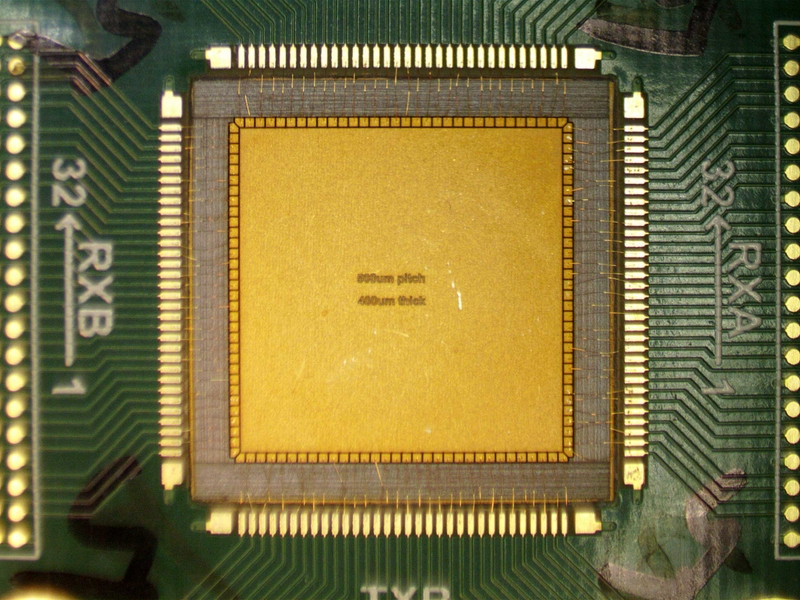 High-resolution microscope captures of the empty square, yellow, surrounded by an array and thin copper wires.
