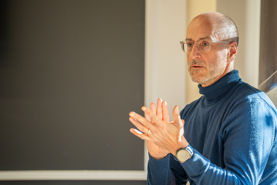 Closeup of Mark Bathe in front of a blackboard