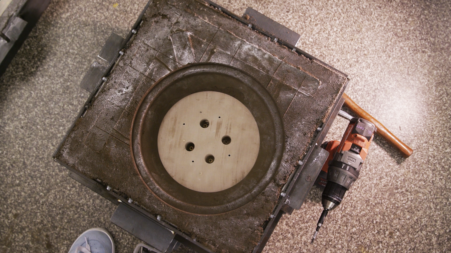 Top-down view of a well-used sand mold for metal casting. 