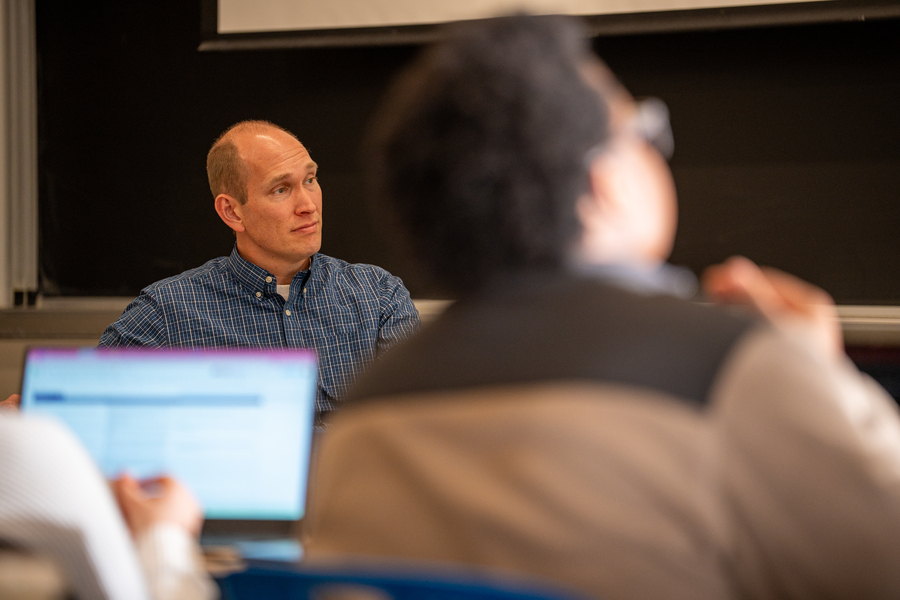 Robin Wolfe Scheffler seated addressing a class