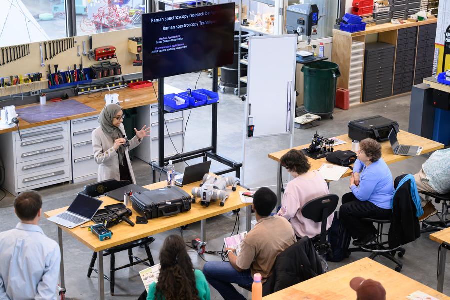 Lamyaa Almehmadi speaks in front of a classroom of seated workshop attendees.