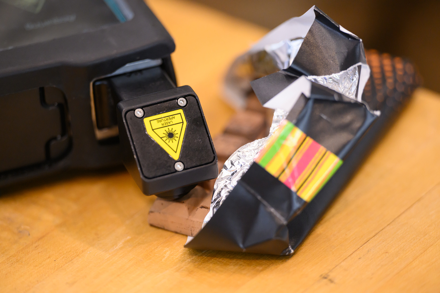A Raman spectrometer is shown with a sample brought by an attendee, a chocolate bar.