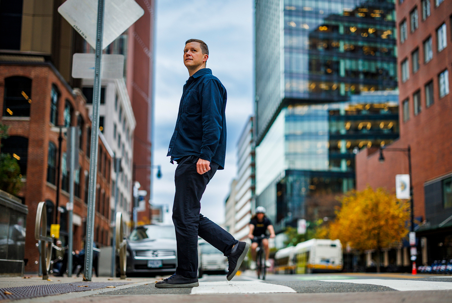 Andres Sevtsuk walks on street in city