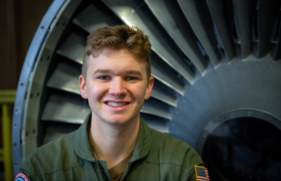 Brian Robinson in front of a large turbine engine