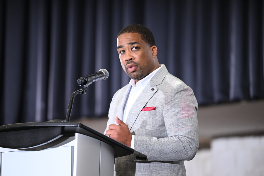 G. Anthony Grant speaks at a lectern indoors