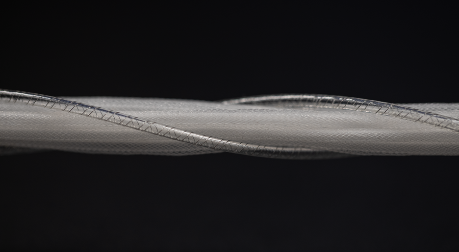 A close-up image featuring a shaft of thin, white, and transparent woven fibers