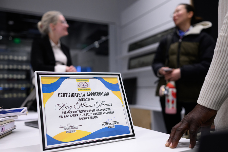 A closeup shot of an award to Amy Moran-Thomas says, “for your continuous support and dedication you have shown to” the Branch.