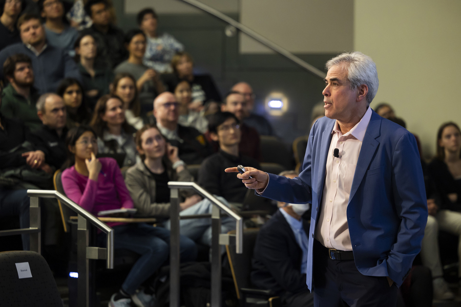 Jonathan Haidt speaks to a full audience in stadium-style seating