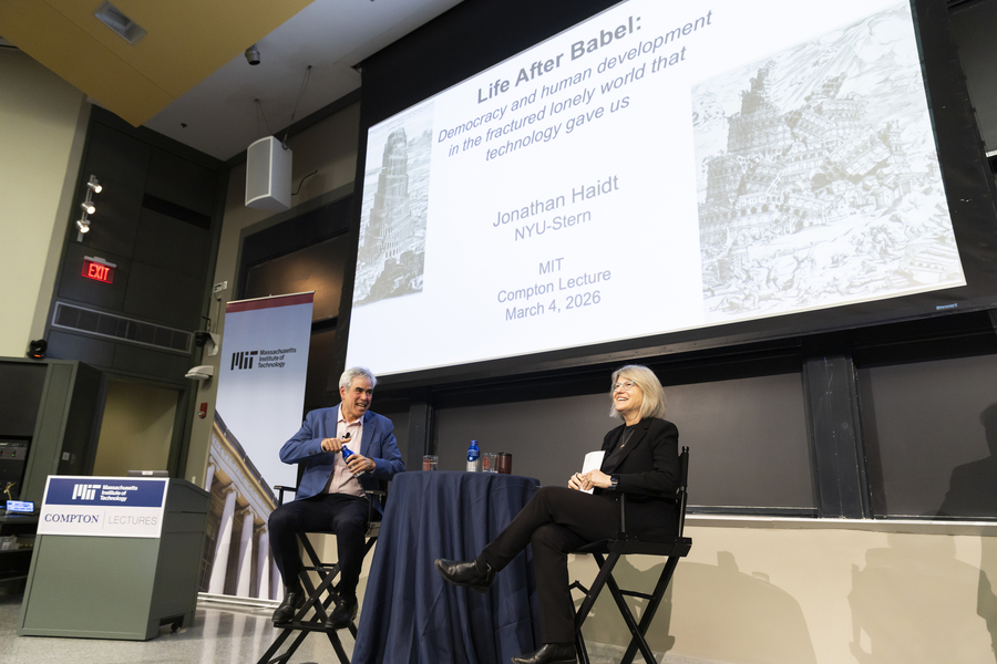 Jonathan Haidt and Sally Kornbluth are seated together at the front of a lecture hall