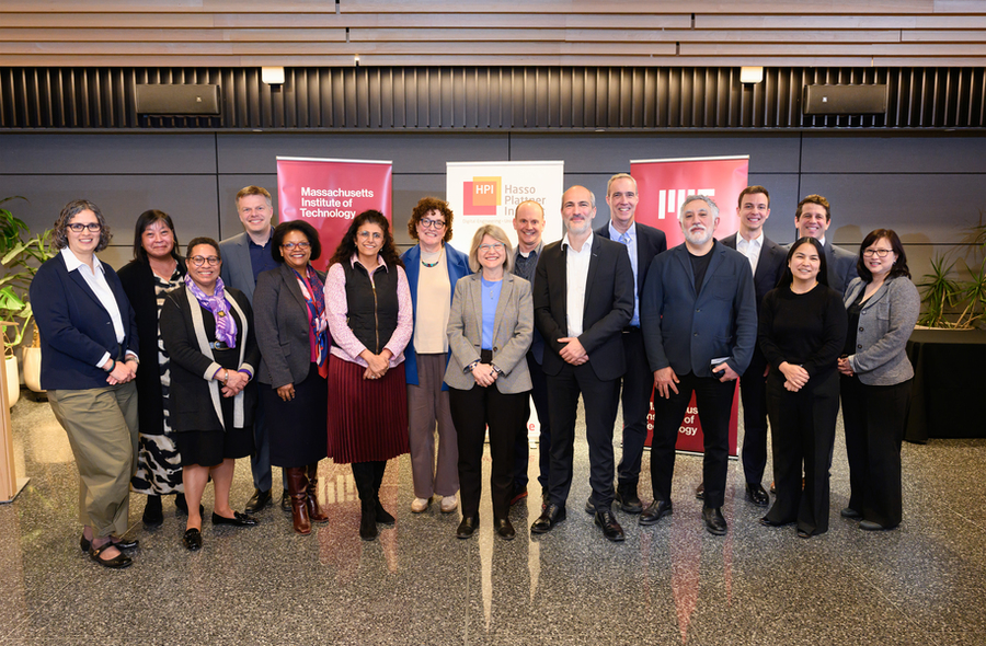 16 people pose for a photo in front of banners for Massachusetts Institute of Technology and Hasso Platner Institute