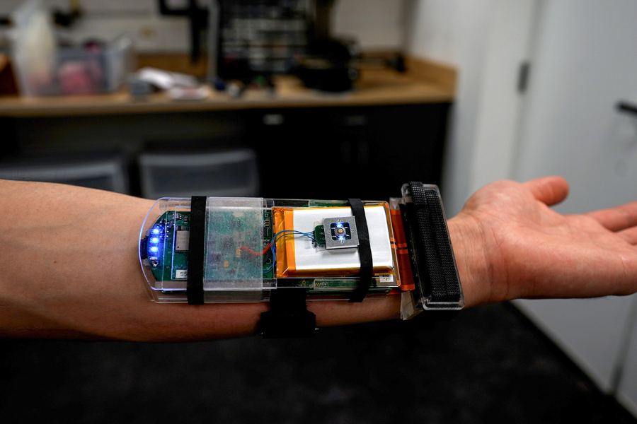 A researcher wearing an ultrasound wristband