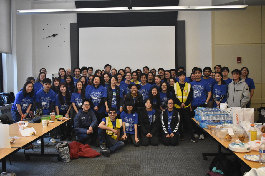 Group photo of roughly 50 people wearing matching T-shirts