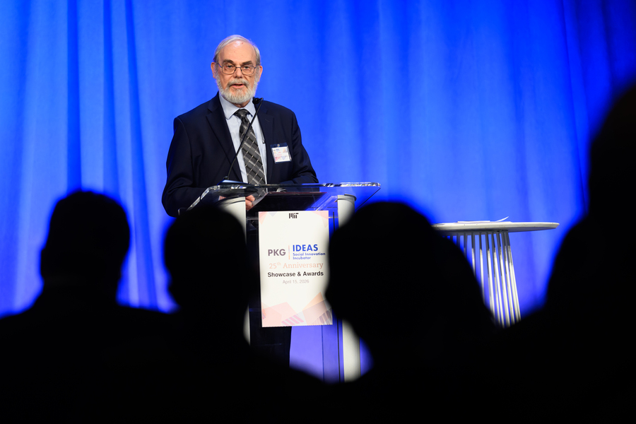 Eric Grimson speaks at a lectern on an indoor stage