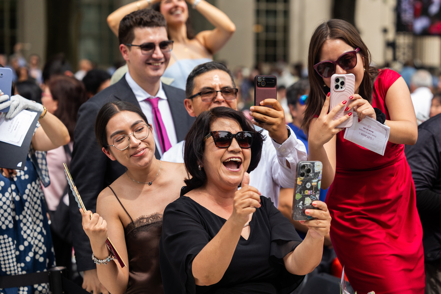 A family cheers on their graduate