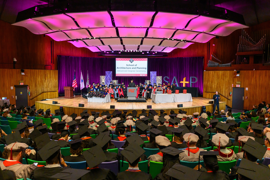 Graduation ceremony taking place at Kresge auditorium while audience of graduates watch