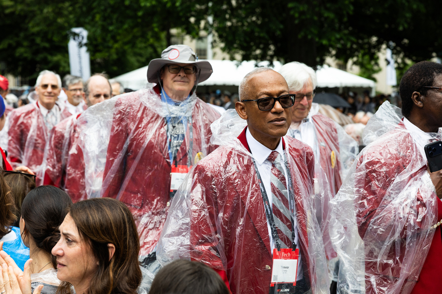 Alumni wear red coats and ponchos