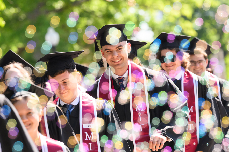 Grads walk in sunshine and bubbles