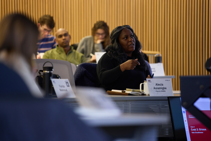 Alecia Asiamigbe looks outside of the frame of the photo, interacting with faculty member during a lecture