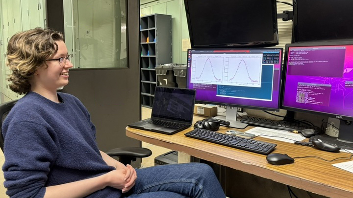 Abigail Bohl looks at a computer screen in an office