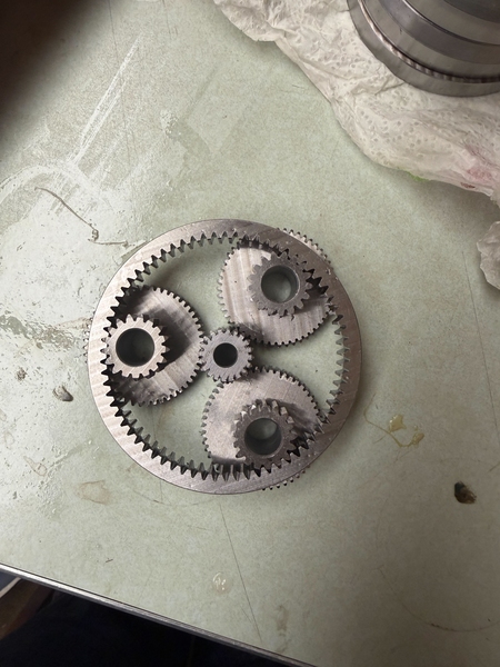 Gearset with a central gear that drives three adjacent gears that propel a surrounding ring