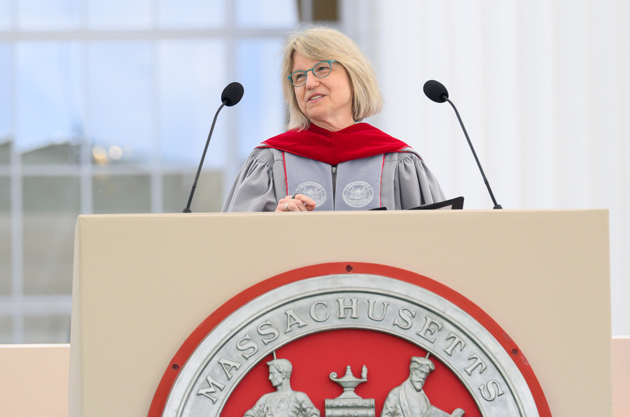 Sally Kornbluth speaks at podium on stage.