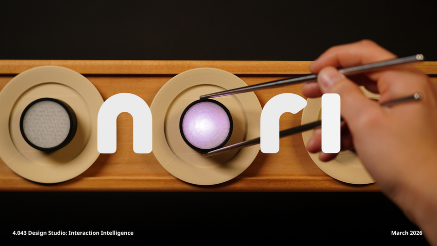 Photo of a hand using chopsticks to hold a LED light that forms the “O” in the word ‘nori’