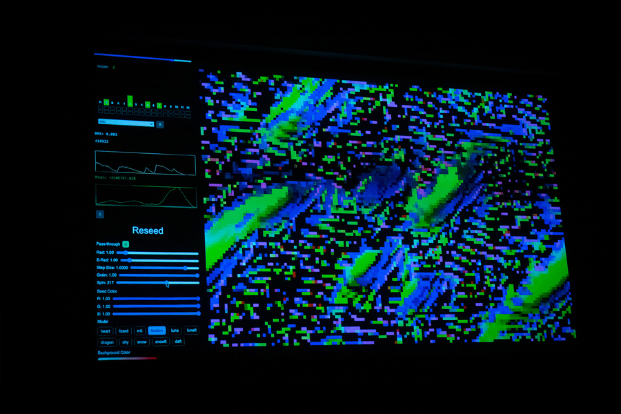 A computer screen emits a pixellated soft green and blue glow.