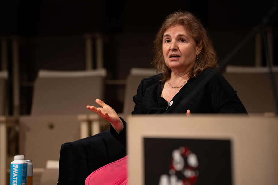 Close-up of Daniela Rus, seated on an indoor stage and speaking 