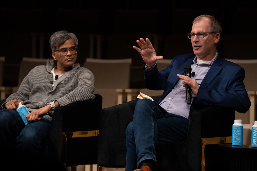 Sendhil Mullainathan watches as David Mindell speak. They're both seated on an indoor stage.