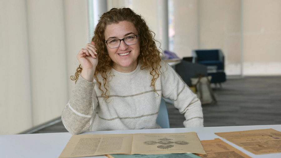 Lerna Ekmekcioglu, seated at a table with old documents on it