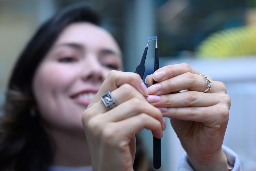 Diana Grass holding a small electronic device