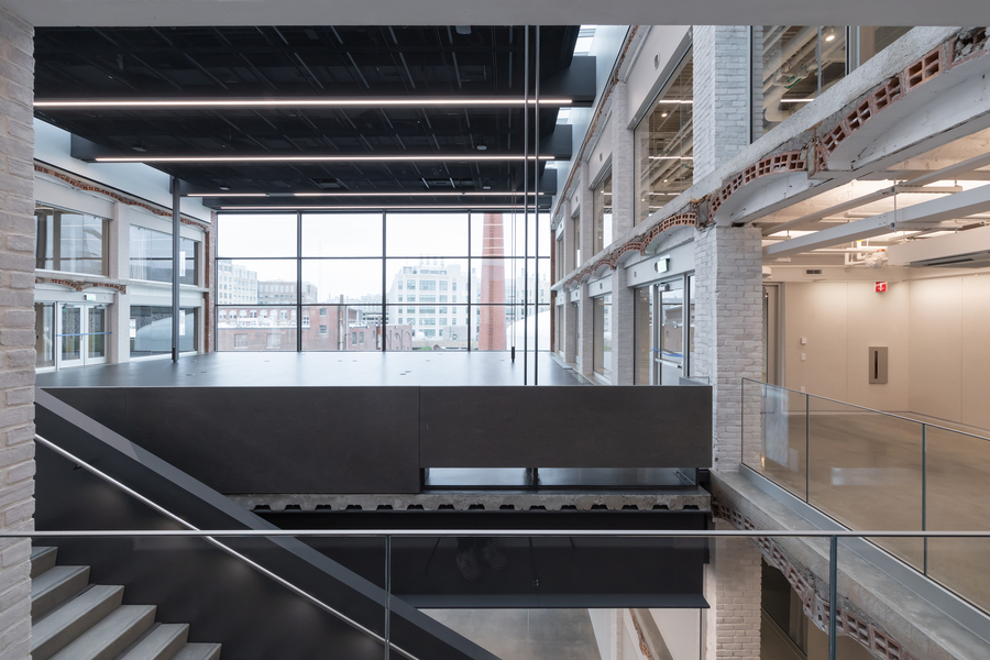 New double-height platform studio suspended within the existing masonry and steel structure