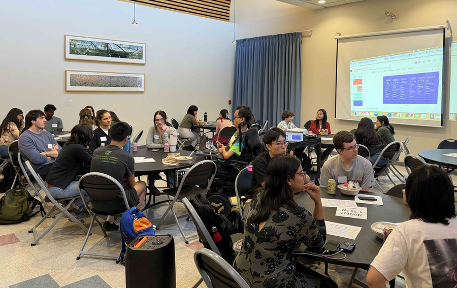 Roughly two dozen students sitting at tables in the dining room of W11.