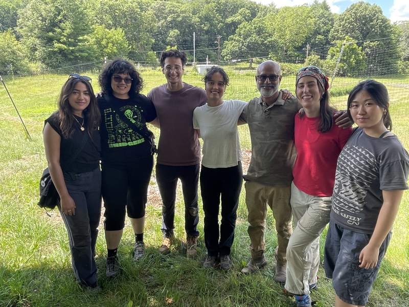7 people pose standing in a field