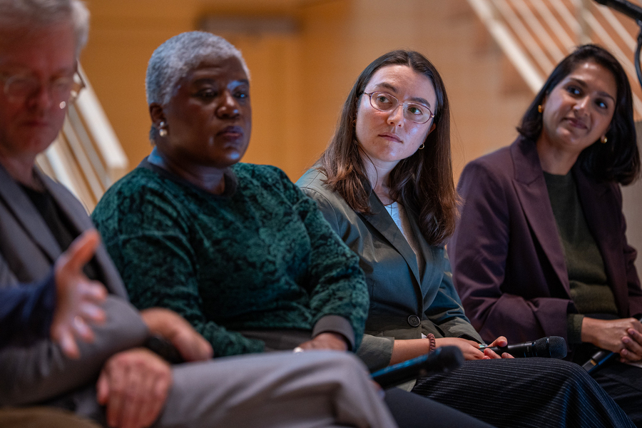 Jay Scheib, Sandy Alexandre, Elise Newman, and Angela Saini are pictured seated together in a close-up, listening to an unseen speaker.