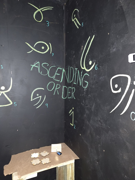 A dark corner of an escape room with possible clues.
