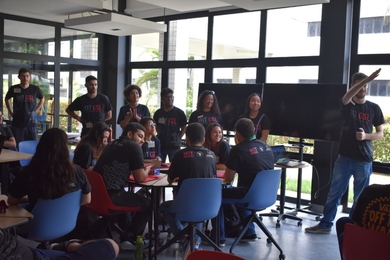 Photo of students in a classroom, all wearing “MIT GSL” T-shirts