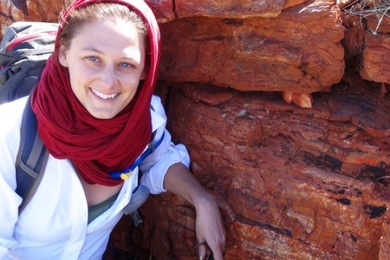 Photo of Tanja Bosak posing in front of an ancient rock