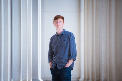 Photo of W. Robb Stewart wearing jeans and a denim shirt, standing with his hands in his pockets