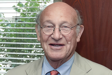 Headshot photo of Donald Bruce Montgomery in front of a window with a plant in the background