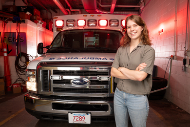 architect research paper topics Abigail Schipper smiles with arms crossed while standing in front of a parked MIT ambulance with red lights on.