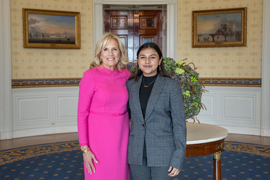 Jill Biden poses arm in arm with Gitanjali Rao in a room of the White House