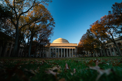 Photo of the MIT Dome and surrounding Killian court in autumn with leaves on the ground