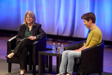 Sally Kornbluth and Sam Altman are sitting on stage in conversation.