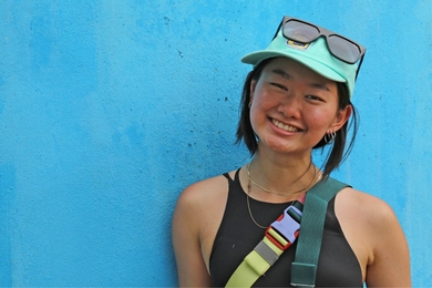 Headshot of Sophia Chen against a bright blue wall