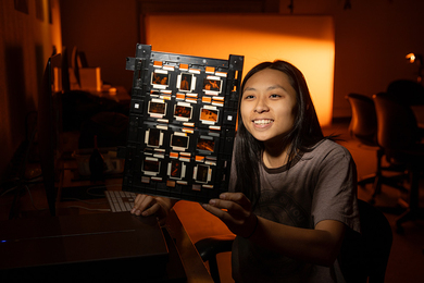 Audrey Chen in a photography studio reviewing a contact sheet layout of negatives