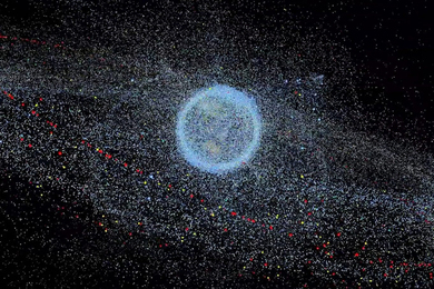 Graphic showing the distribution of space debris, as seen as thousands of tiny light blue dots around planet Earth