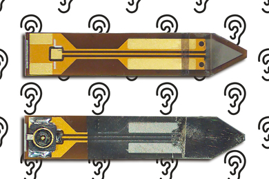 Two sides of a tiny, thin arrow-shaped device with circuits.