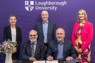Rachel Thompson, Eric Grimson, Yossi Sheffi, Nick Jennings, and Jan Godsell pose at an agreement signing ceremony. The words "Loughborough University" are on the wall behind them.