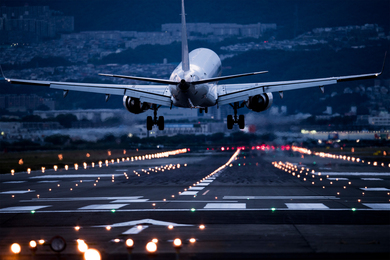 A commercial airplane approaching a runway